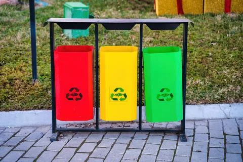 Iron multi-colored containers for separate waste collection. Stock Photos