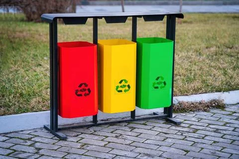 Iron multi-colored containers for separate waste collection. Stock Photos