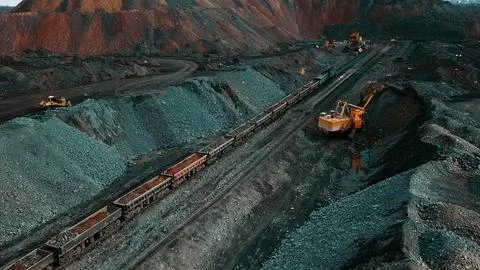 Iron ore quarry loading and transportation, aerial view Stock Photos