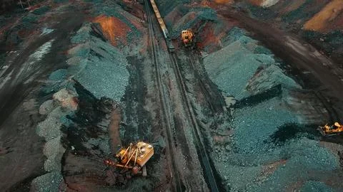 Iron ore quarry loading and transportation, aerial view Stock Photos