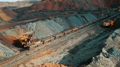 Iron ore quarry loading and transportation, aerial view Stock Photos