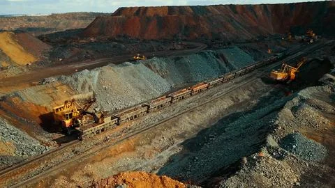 Iron ore quarry loading and transportation, aerial view Stock Photos
