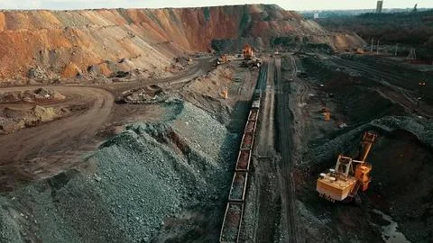 Iron ore quarry loading and transportation, aerial view Fotos de archivo