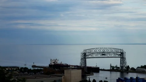 Iron ore ship going under the historic aerial lift bridge in Duluth MN Stock Footage 93768657