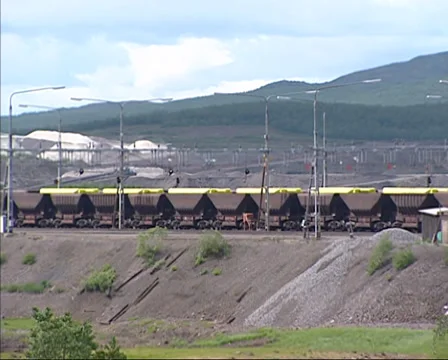 Iron ore shuttle train carriages riding in mining landscape, Kiruna, Sweden Stock Footage 32383397