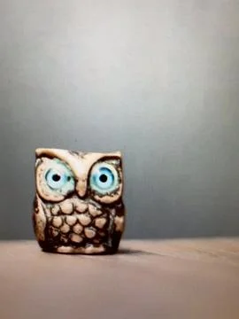 Iron owl standing on table . Stock Photos