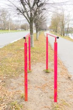 Iron, painted parallel bars for pulling up are installed on embankment near r Stock Photos