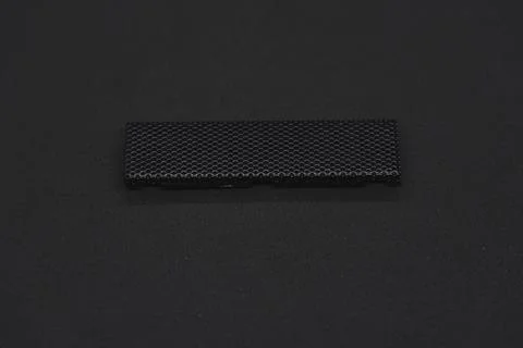 The iron panel from the computer. Iron black mesh panel. Metal rectangular .. Stock Photos