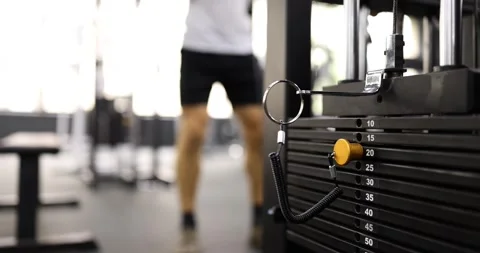 Iron plates with choice of weights are stacked on sports simulator against Video stock 267862584