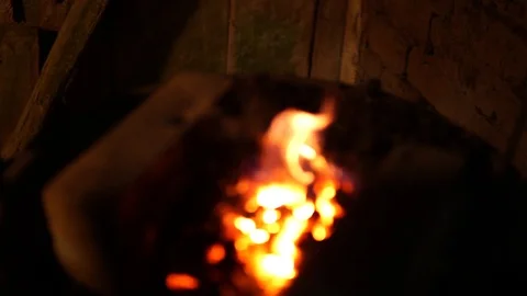 Iron ready for forging being pulled from hearth fire slow mo 動画素材 89539122