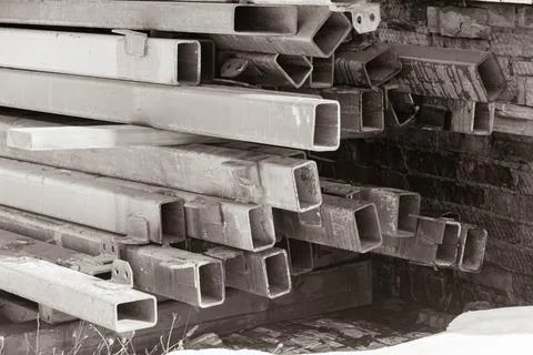 Iron rectangular pipes. Construction fittings. Metal materials for construction. Stock Photos