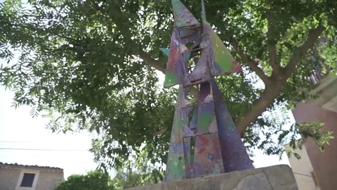 Iron sculpture with tree behind Stock Footage 134605979