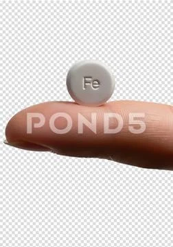 Iron supplement tablet balanced on finger, health and anemia treatment concept Modèle PSD