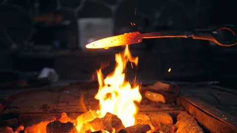 Iron tool is getting heated above the fire Stock Footage 114889053