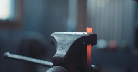 Iron in a vice being hammered by blacksmith Stock Footage 105307159