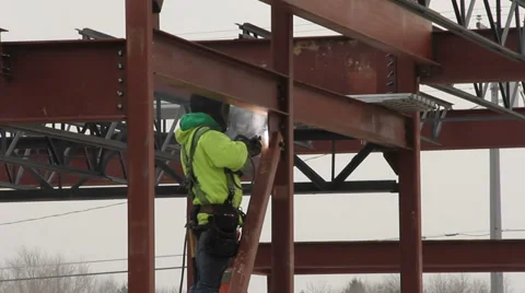 Iron worker welding I- beams Stock Footage 37871824