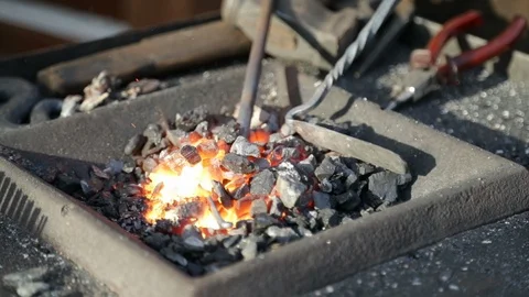 Iron working in burning coal Stock Footage 100610100