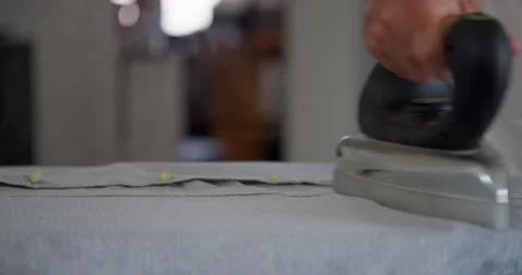 Ironing clothes on a board: Stock Footage 344315082