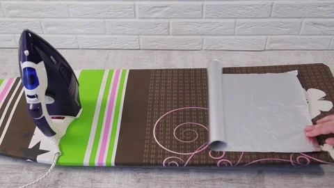 IRONING OF CLOTHES ON FOIL Stock Footage 155411736