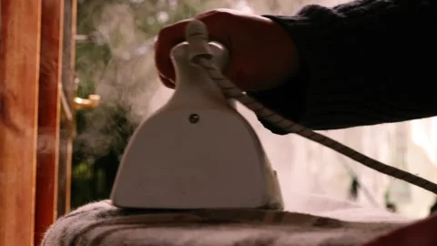 Ironing laundry with steam iron Stock Footage 277590859