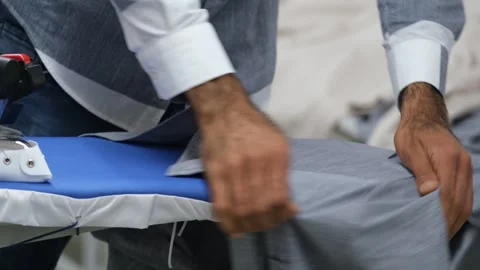 Ironing process in clothes factory Video stock 294110606
