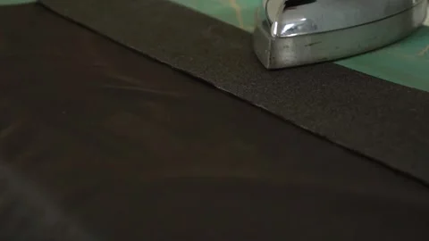 The Ironing Process for Dark Fabric Using Steam to Ensure Optimal Results and Stock Footage 310266451
