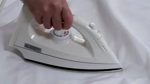 Ironing a white cloth. Stock Footage 234282805
