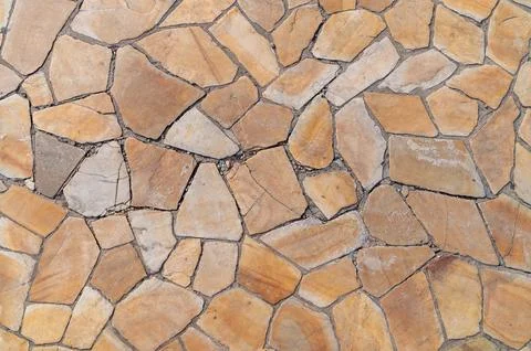 Irregular flagstone paving creating mosaic pattern on outdoor ground Stock Photos