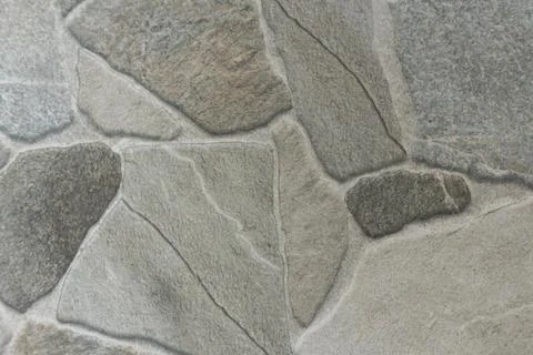 Irregular flagstone paving texture background with grey and beige stones an.. Stock Photos