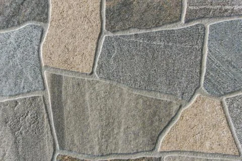 Irregular flagstone paving texture background with grey and beige stones an.. Stock Photos