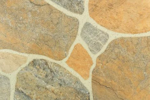 Irregular flagstone paving texture background with grey and beige stones an.. Stock Photos