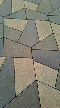 Irregular geometric paving stones texture on city sidewalk. Stockfoto's