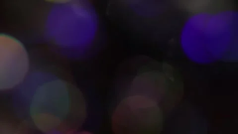 Irregular movement of colored bokeh from close-up to the left Stock Footage 317460116