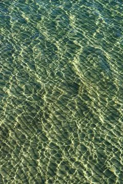 Irregular pattern on the surface of seawater above a sandy surface Stock Photos