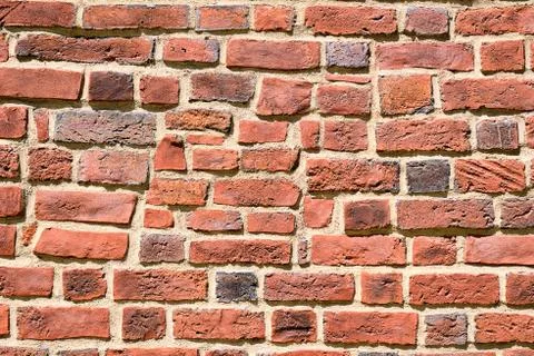 Irregular red brick wall Stock Photos