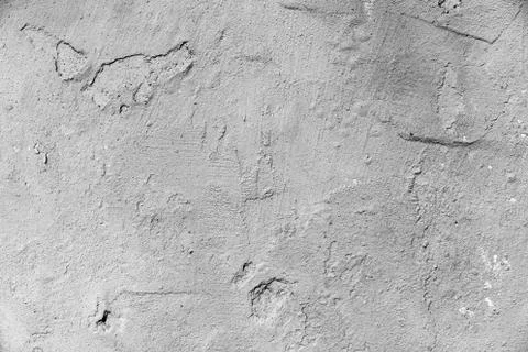 An irregular, rough wall painted in gray, like a background Stock Photos