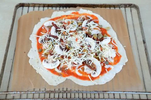 Irregular shape raw pizza before baking - close up Stock Photos