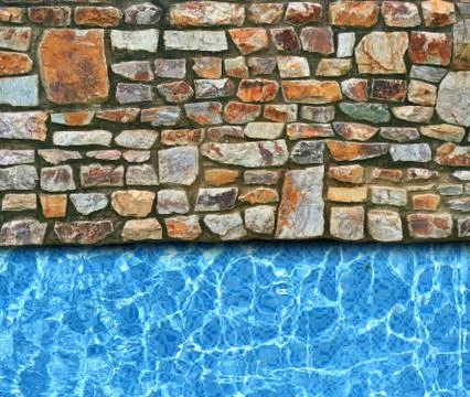 Irregular stone pavement with pool background Stock Photos