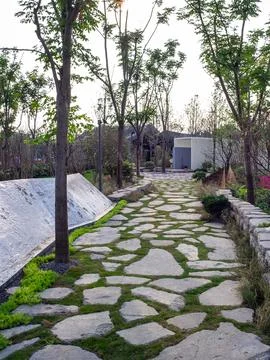 Irregular stone stepping path in a green garden - Harmony concept Stock Photos