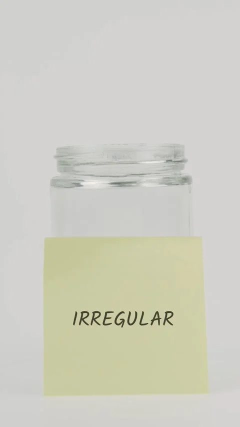 Irregular text or word on yellow sticky note attached to glass jar with hand Stock Footage 311749370