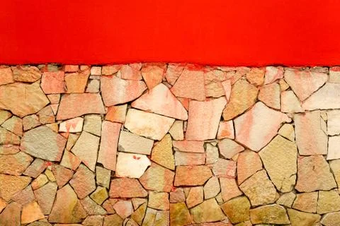 Irregular tiled wall with a red painted wall with copyspace Stock Photos