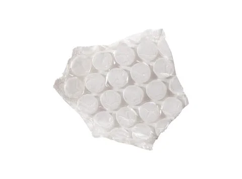 An irregular torn piece of bubble wrap with circular cells and creased plasti Stock Photos