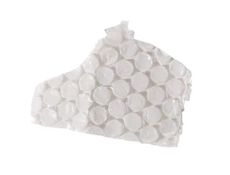 Irregular torn piece of transparent bubble wrap with round air cells and Stock Photos