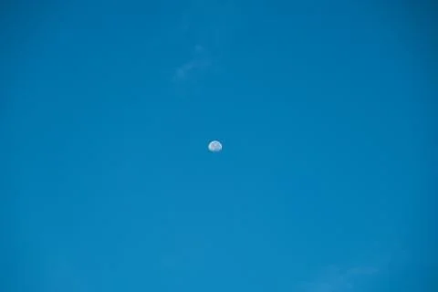 Irregular white cloud on blue sky with small the Moon in the daytime Stock Photos