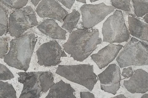 Irregularly patterned natural stone wall texture with dominant gray and bro.. Stock Photos