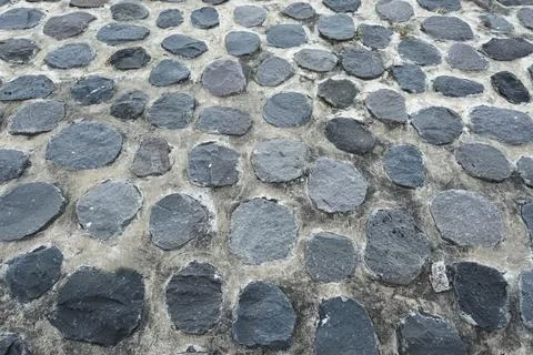 Irregularly patterned natural stone wall texture with dominant gray and bro.. Stock Photos