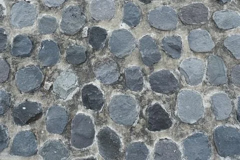 Irregularly patterned natural stone wall texture with dominant gray and bro.. Stock Photos