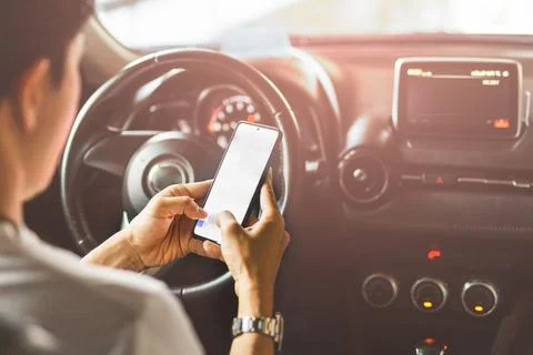 Irresponsible man using smart phone while driving. Stock Photos