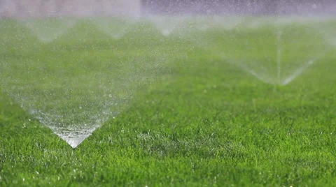 Irrigating grass with water sprinkler Stock Footage 29653537