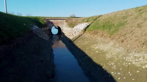 Irrigation canal passes under the bridge Stock Footage 296480840
